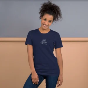 Female model wearing navy aquí amañado tee with pronunciation, studio portrait